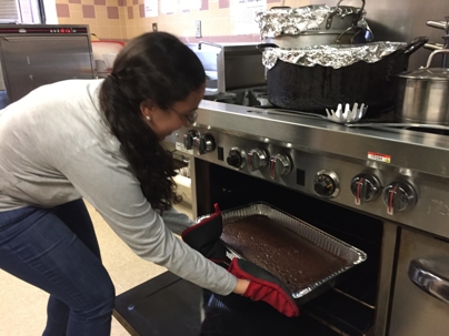 Woman puts pan in the oven