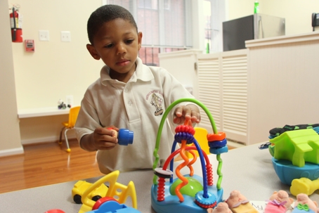 Kid plays with colorful toy