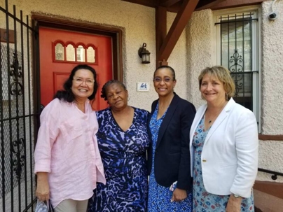 Women in front of red door