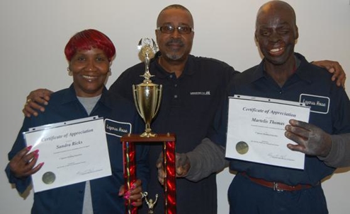 Staff holding awards