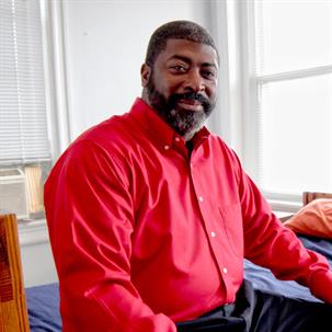 Man in red shirt smiling